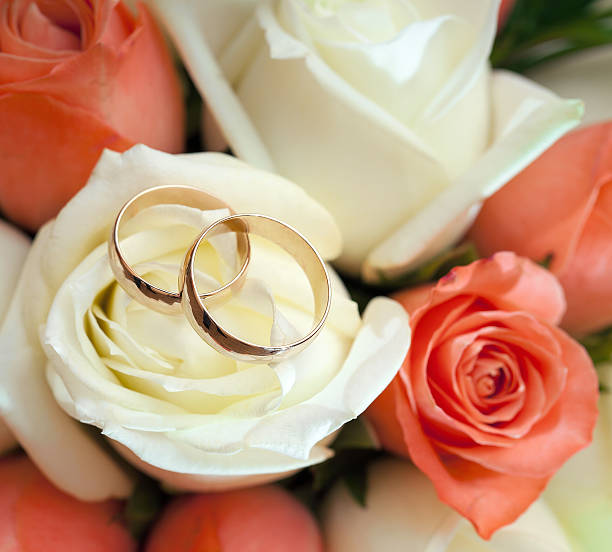 istock wedding rings  groom and bride on a bunch of flow 452973523