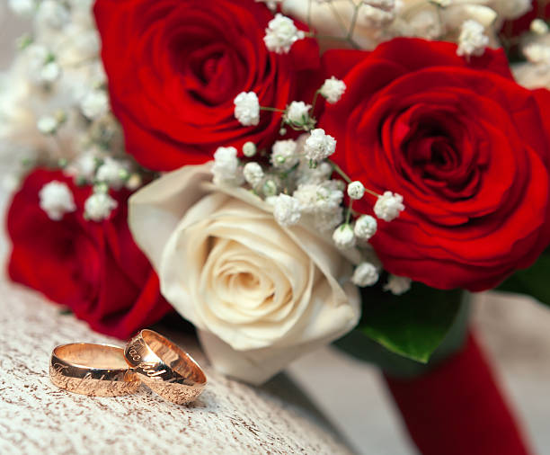 istock wedding rings  groom and bride on a bunch of flow 452975315