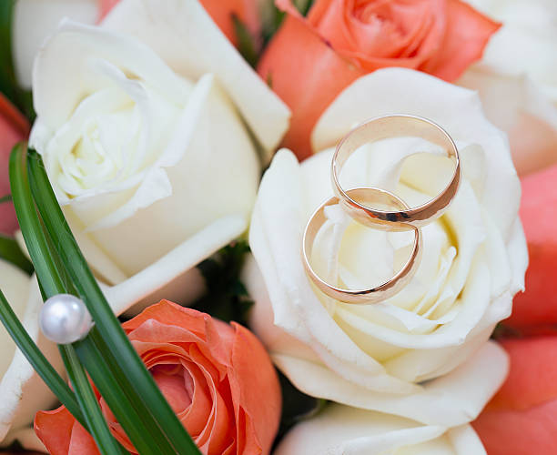 istock wedding rings  groom and bride on a bunch of flow 452976021