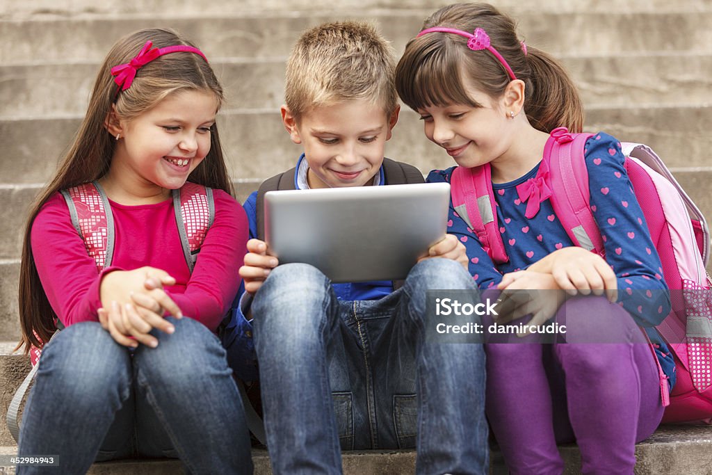 School children using digital tablet outside 8-9 Years Stock Photo