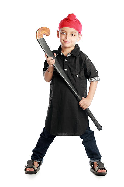 Sikh child with hockey stick