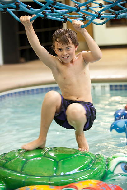 istock Young boy playing at the indoor water park 452987067