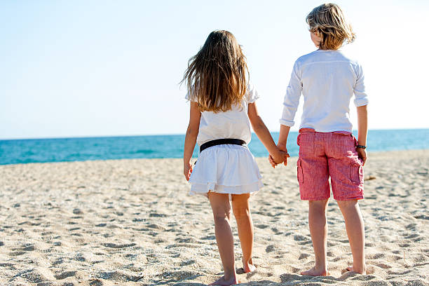 istock Boy and girl looking at sea. 452989603