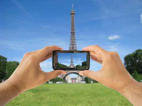 tourist taking a picture with your mobile phone eiffel tower