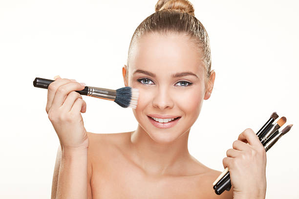 istock Pretty girl posing with make up brushes 452990203