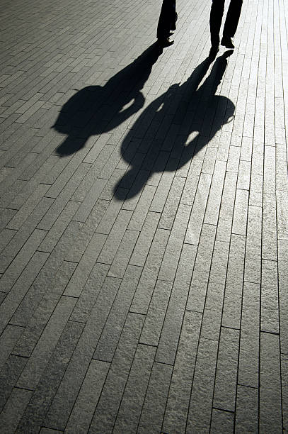 istock Businessman Shadows Walk on Smooth Modern Background 452991231