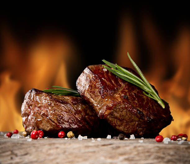 istock Close-up of two juicy beef steaks with garnish 452993021