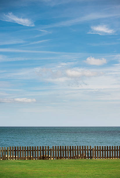 istock Nature with sea, fence and grass 452993613