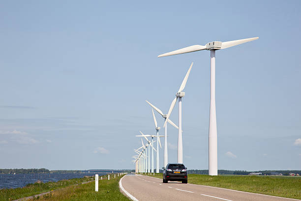 istock row of wind turbines and car 452997901