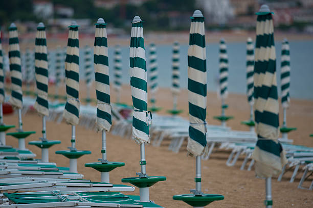 Row of beach umbrellas in a beach resort of Marcelli di Numana in Marche