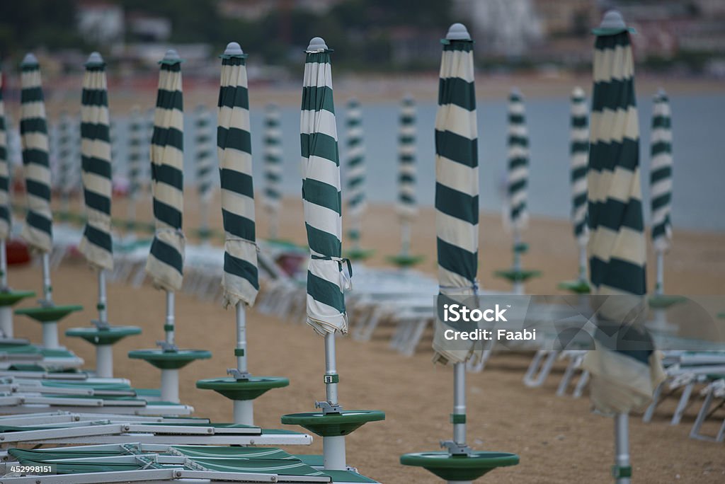 Row of Beach Umbrellas Row of beach umbrellas in a beach resort of Marcelli di Numana in Marche Beach Umbrella Stock Photo