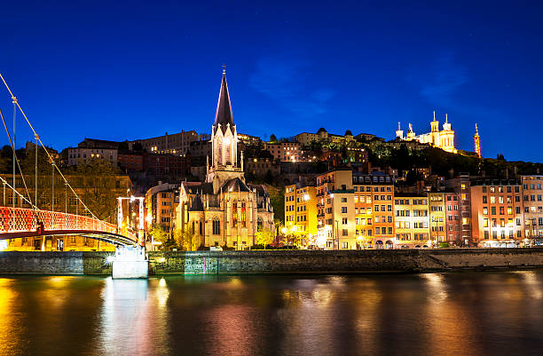 View from Sa͉ne River in Lyon, France night view from St Georges footbridge in Lyon city with Fourviere cathedral, France fourviere stock pictures, royalty-free photos & images