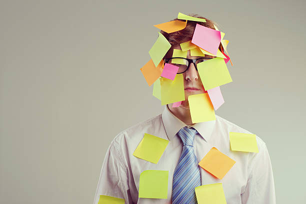 Post-it man Office worker with post-its all over his face overworked funny stock pictures, royalty-free photos & images