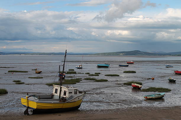 Morcambe Bay A boat in the foreground of Morecambe bay, looking east across to the lake district morecombe bay photos stock pictures, royalty-free photos & images