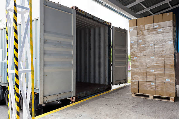 An opened truck on a loading dock Forklift with carton boxes loading the truck cargo container container open shipping stock pictures, royalty-free photos & images