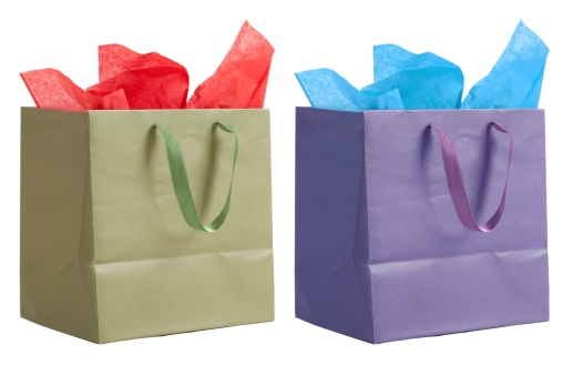 A green and red and purple and blue gift bag isolated on white.
