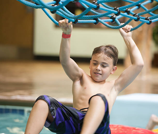 istock Young boy playing at the indoor water park 453012061