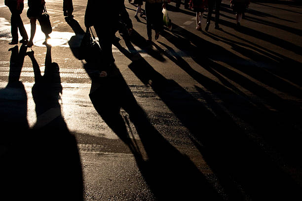 istock Shadows of people walking street 453014623