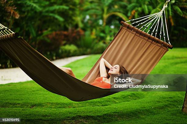 Woman Relaxing In Outdoor Hammock Over Green Grass Stock Photo - Download Image Now - Adult, Backgrounds, Day