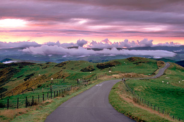 Wales, Powys, near Machynlleth, storm cloud sunset, winding road