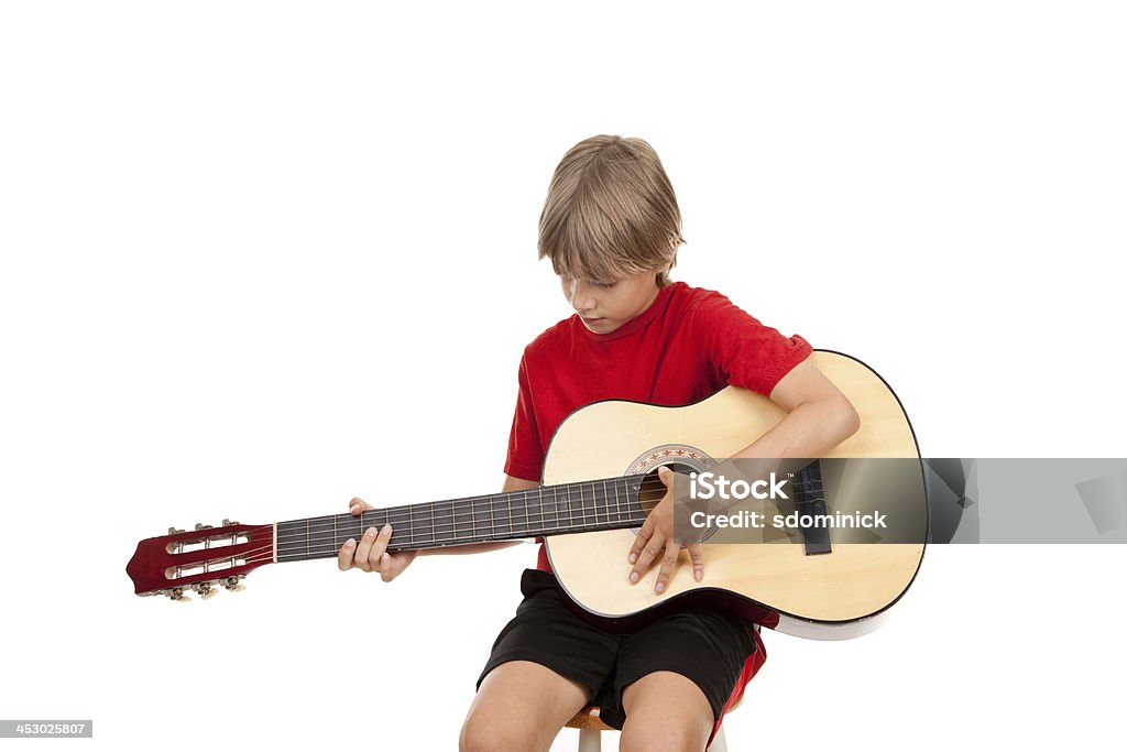 Young Boy aprender a jugar guitarra acústica - Foto de stock de 8-9 años libre de derechos