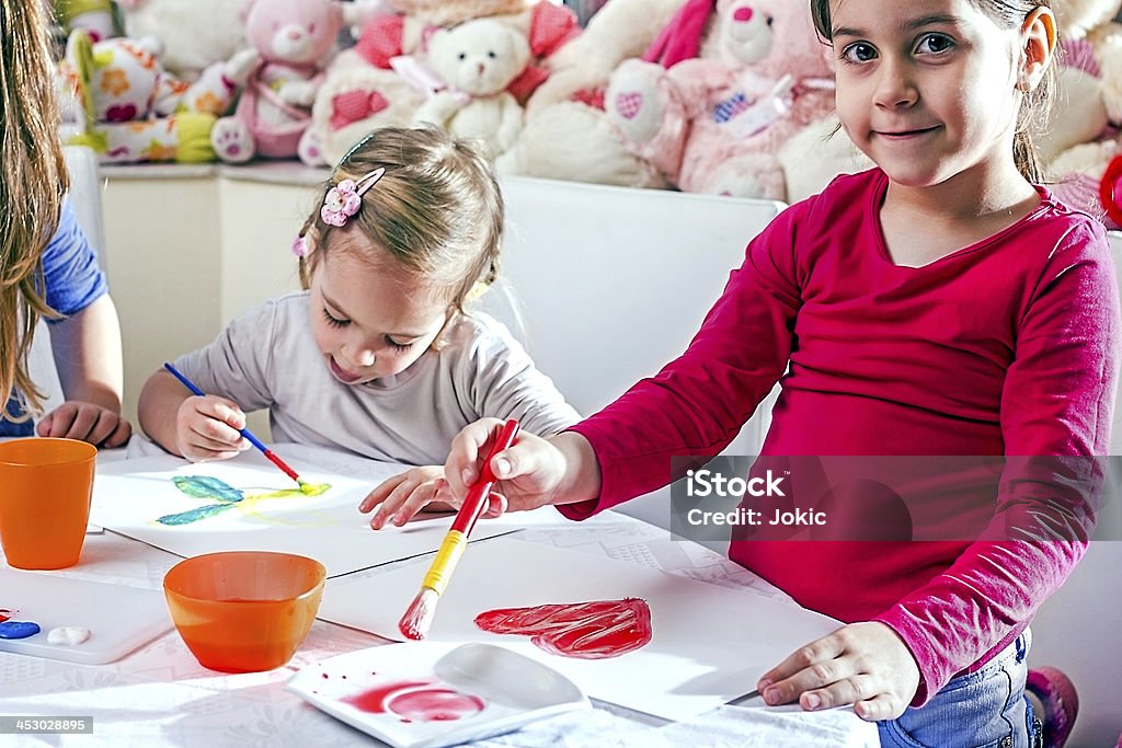 Children painting. Happy children painting in their room. 2-3 Years Stock Photo