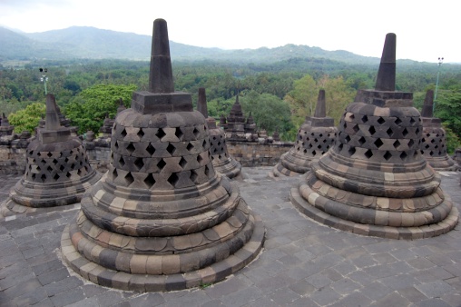 Borobudur temple in central Java, view from the top, a popular tourist destination in the indonesian island. Local people and tourists sightseeing the ancient buddhist site
