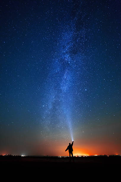 man on the background of bright stars  night sky. The man on the background of bright stars of the night sky. The Milky Way. north star stock pictures, royalty-free photos & images