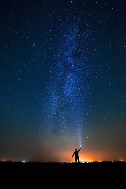 istock man on the background of bright stars  night sky. 453034569