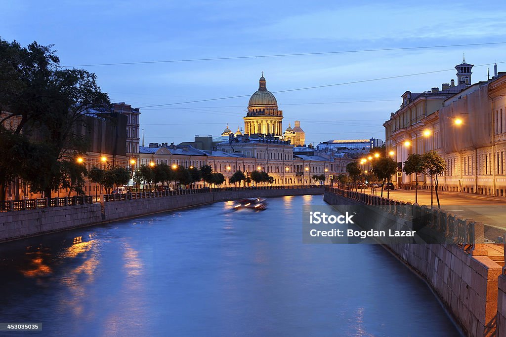 Saint Petersburg, Russia Moyka canal in downtown Saint Petersburg, Russia at twilight with the dome of Saint Isaac Cathedral in the skyline. Architectural Dome Stock Photo