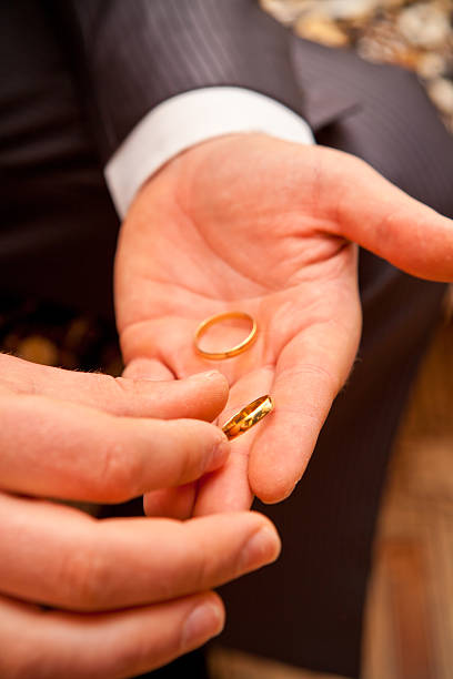 istock groom holds the wedding ring 453037723