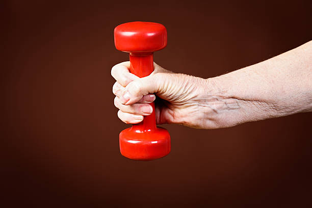 istock Seniors need to keep fit too! Elderly arm pumps iron 453043887