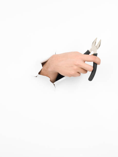 istock male hand holding plier 453044055