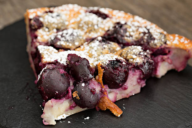 Bing Cherry Clafoutis A close up shot of a slice of freshly baked Bing cherry clafoutis. clafoutis stock pictures, royalty-free photos & images