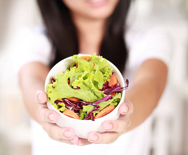 istock Salad bowl in woman hands 453045123