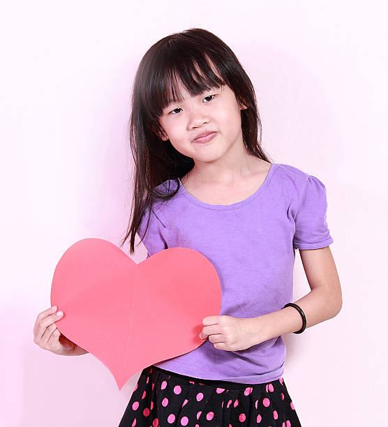 istock girl and heart shape paper 453045803