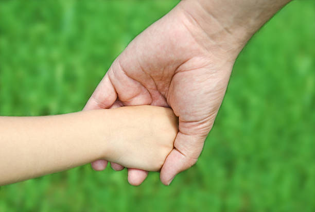 istock Child holds hand of the father 453050381