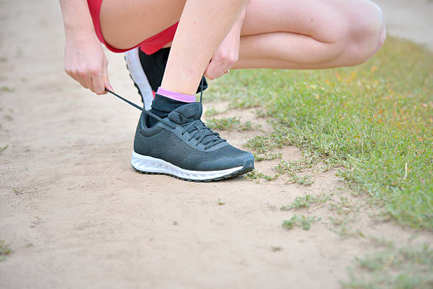 istock Woman tieing shoe 453050741