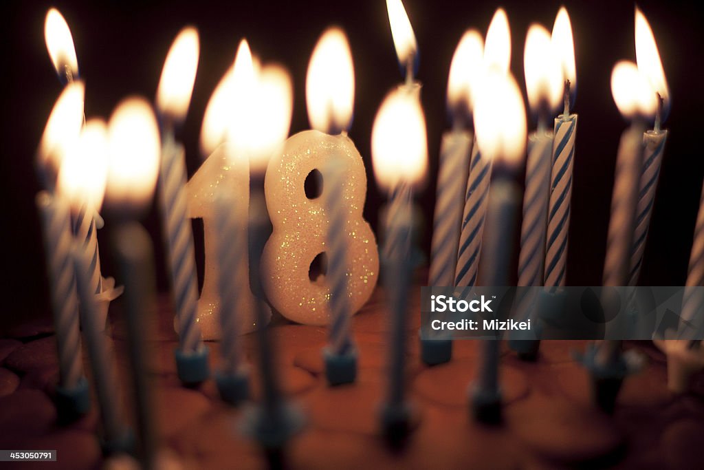 Eighteenth Birthday Cake Birthday cake with lit candles including '18' candle 18-19 Years Stock Photo