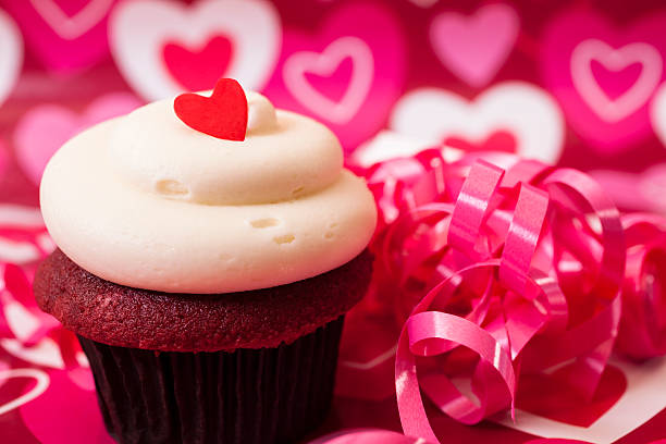 istock Valentine's Day: Cupcake with red heart on top.  Ribbon decorations. 453052685