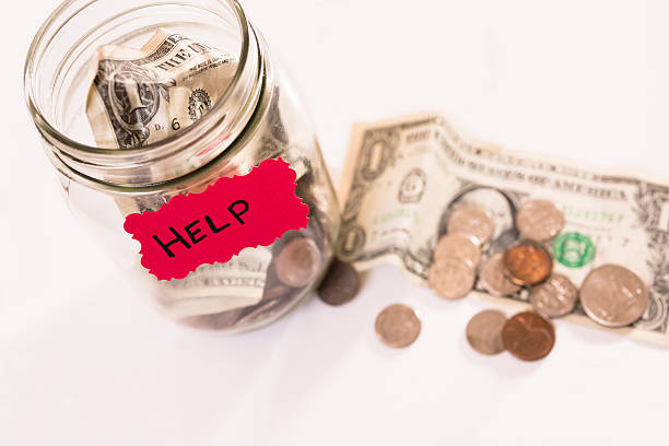 istock Volunteerism:  Money Jar with coins, dollar bills.  Help.  Donation, fundraiser. 453054091