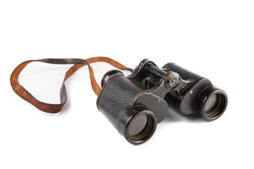 Black old military binoculars isolated on white background