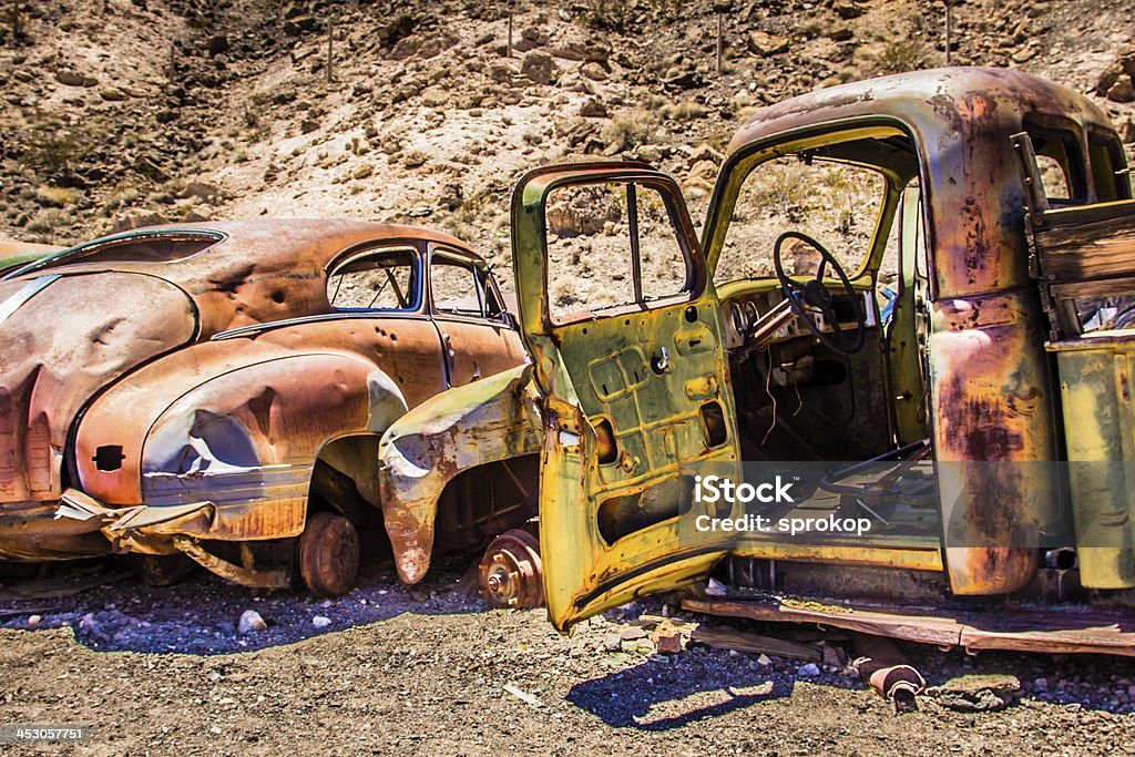 Rusty Car in the Desert Old Rusty Car and truck in the Desert Abandoned Stock Photo