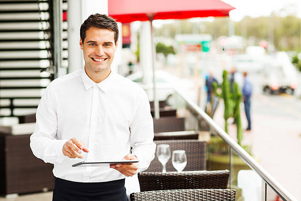 istock Waiter With Digital Tablet Smiling In Restaurant 453058625