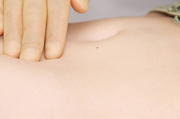 istock Palpation of young woman's stomach 453059055