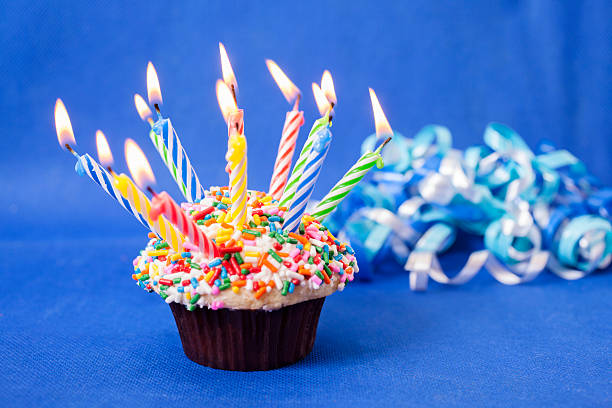istock Cake and Candles: Birthday cupcake with many burning candles. Sprinkles. 453059683