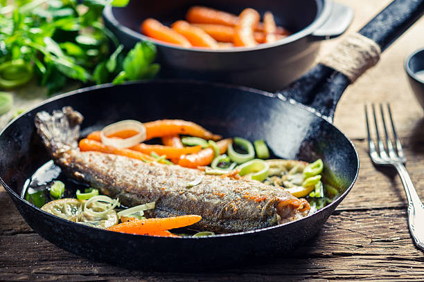 istock Closeup of freshly fried fish with lemon and carrots 453062185