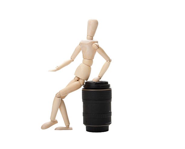 Wooden mannequin and photo lens