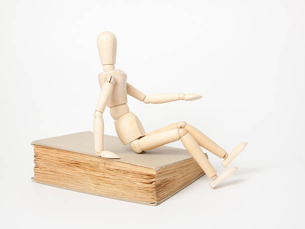 istock Wooden man and book 453062393