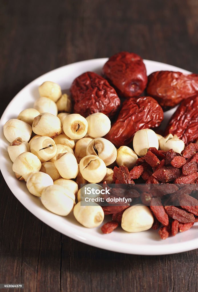 Traditional Chinese Herbal Medicine Traditional Chinese Herbal Medicine in plate on wooden background Agriculture Stock Photo